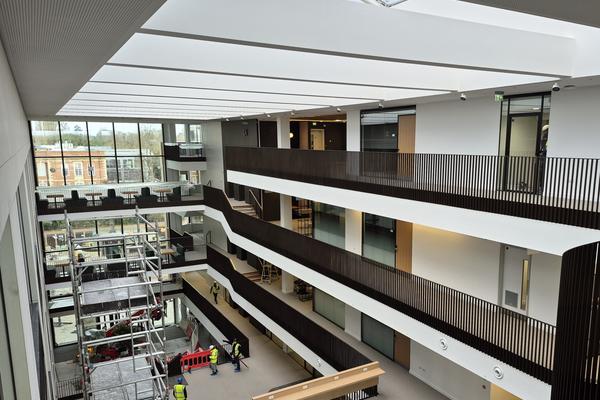 Main atrium of the Life and Mind Building from the upper floor, looking towards the main entrance, largely completed but with some scaffolding and construction work ongoing